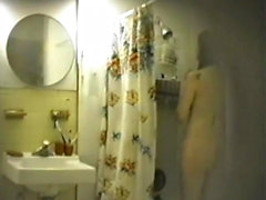 Stunning chick caught changing in the bathroom